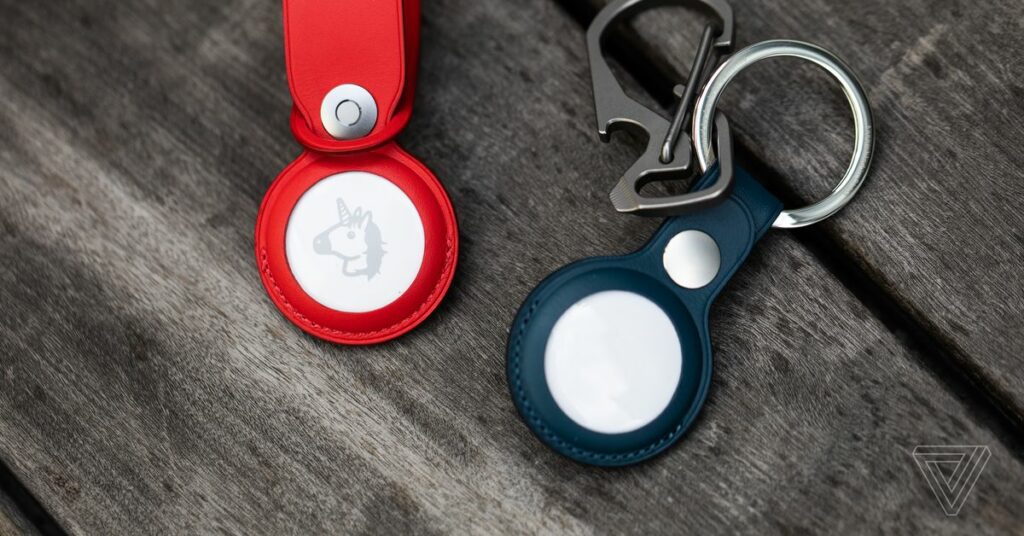 A photo showing two Apple AirTags in keychain cases